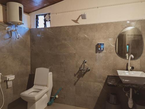 a bathroom with a toilet and a sink at Sunset Cafe Beach Stay in Gokarna