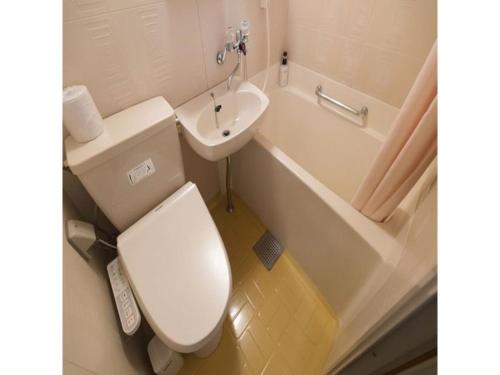 a bathroom with a toilet and a sink and a tub at Hotel Axia Inn Kushiro - Vacation STAY 67227v in Irifunechō