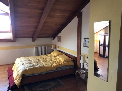 a bedroom with a bed and a wooden ceiling at Villa Bonelli Bed & Fest in Savigliano