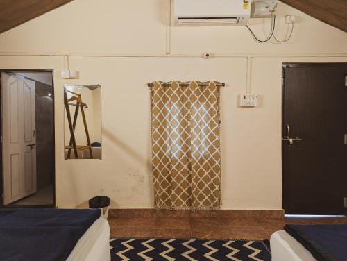 a room with two beds and a window at Sunset Cafe Beach Stay in Gokarna