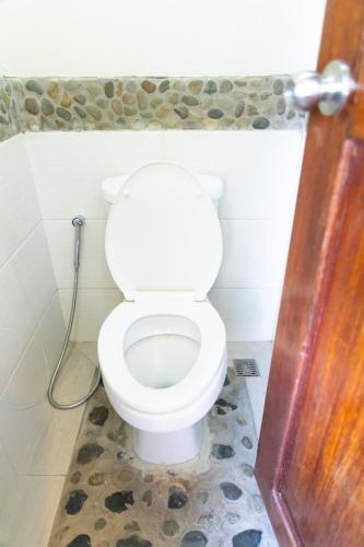 a bathroom with a white toilet in a room at Marianne Port Barton in San Vicente