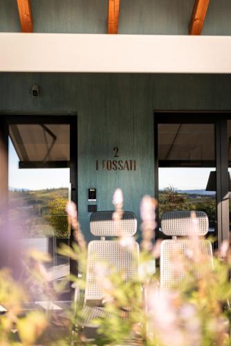 a group of chairs sitting in front of a building at VINEHO in Barolo