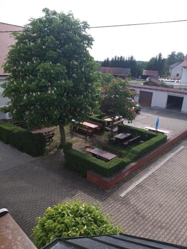 an overhead view of a park with a tree and benches at Landgasthof Haagen in Schwabhausen bei Dachau