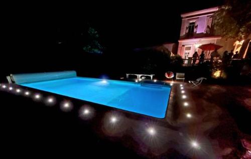 a swimming pool in the middle of a yard at night at Mes nuits au château au domaine du pressoir in Pierrefeu-du-Var