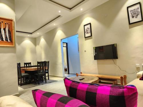 a living room with a couch and a table at Moshi Epic Accommodation in Moshi