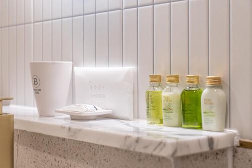 three bottles of liquid sitting on a counter at Browndot hotel Gimhae cityhall in Gimhae