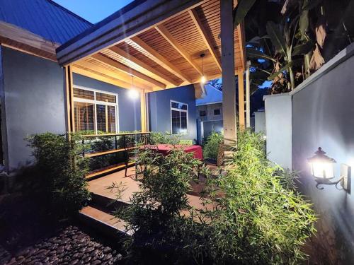 a patio with a table and chairs on it at Moshi Epic Accommodation in Moshi