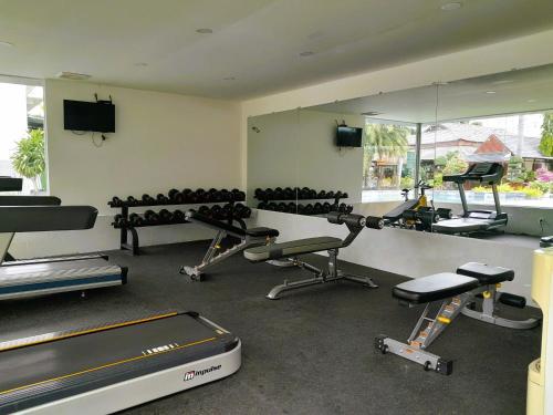 a gym with several exercise bikes and a mirror at The Mira Boutique Hotel in Thu Dau Mot