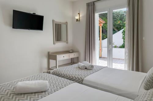Postel nebo postele na pokoji v ubytování Pano Stalos Villas