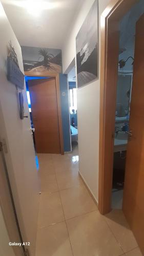 a hallway with a door leading to a bathroom at Los Abrigos 2 apartments Guest House Ocean relax, wifi, playas in Los Abrigos