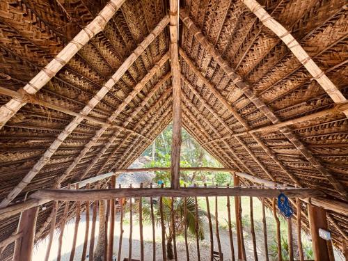 a large bamboo building with a large window at Villa LA Kurumba in Ambalangoda
