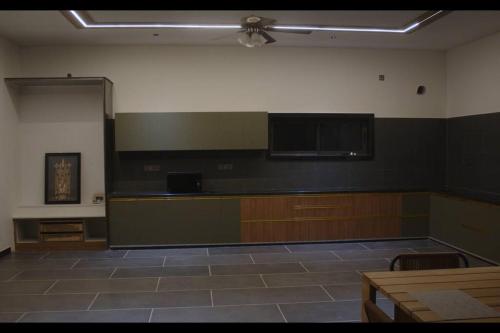 an empty room with a large room with a ceiling at Arr farm stay in Shamshabad
