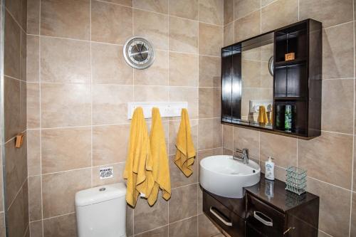 a bathroom with a toilet and a sink at 7 Saint Andrew in White River