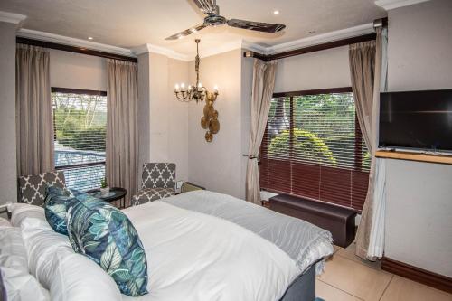 a bedroom with a bed and a flat screen tv at 7 Saint Andrew in White River