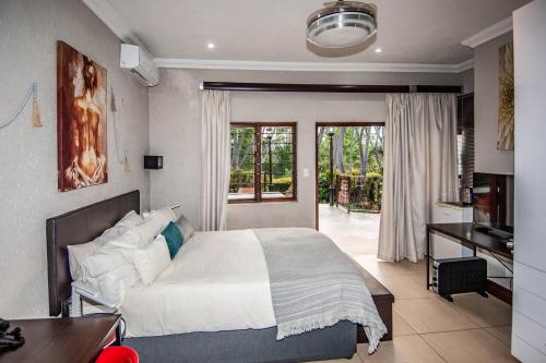 a bedroom with a bed and a desk and a table at 7 Saint Andrew in White River