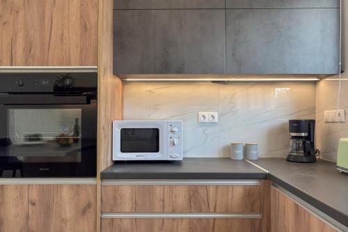 a microwave sitting on a counter in a kitchen at AéNaos Luxury Villa with Pool in Galatas in Galatás