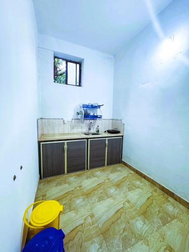 an empty kitchen with a counter and a sink at VCS Apartments Parassinikadavu in Parassinikadavu