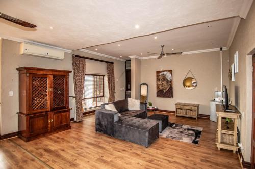 a living room with a couch and a table at 7 Saint Andrew in White River