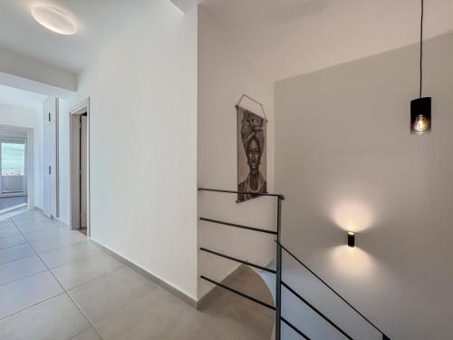 a staircase in a house with a white wall at AéNaos Luxury Villa with Pool in Galatas in Galatás