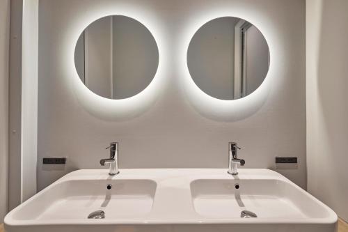 two mirrors above a white sink in a bathroom at Spacious Tokyo Base near Tamachi station Hotel Ten Tamachi in Tokyo