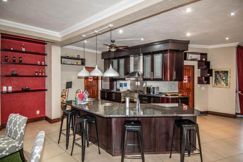 a kitchen with a large island with bar stools at 7 Saint Andrew in White River