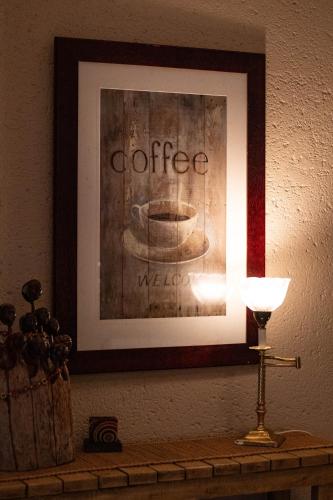 a picture of a coffee maker on a table with a lamp at 7 Saint Andrew in White River