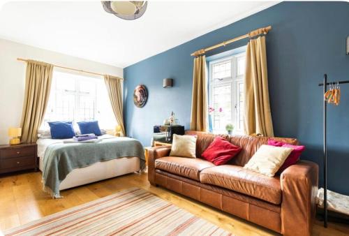 a living room with a couch and a bed at Kingswood in Bromley