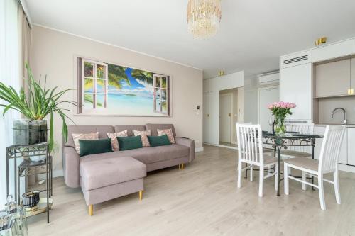 a living room with a couch and a table at Your Holidays Waves in Międzyzdroje