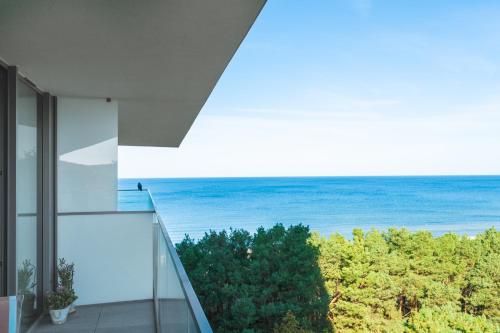 a view of the ocean from the balcony of a house at Your Holidays Waves in Międzyzdroje