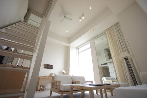 a living room with a loft bed and a table at Hotel Marinoa Resort Fukuoka in Fukuoka