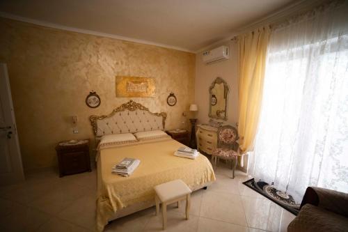 a bedroom with a bed and a dresser and a window at Duchessa Katia Accomodation Tropea in Tropea
