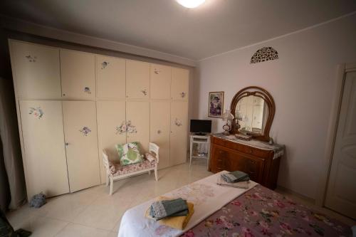 a bedroom with a bed and a mirror and a chair at Duchessa Katia Accomodation Tropea in Tropea