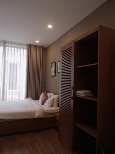 a bedroom with a bed and a book shelf at 5mins Hostel Dalat in Da Thanh
