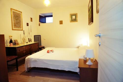 a bedroom with a bed and a table and a window at La Campagna del Benessere in Gildone