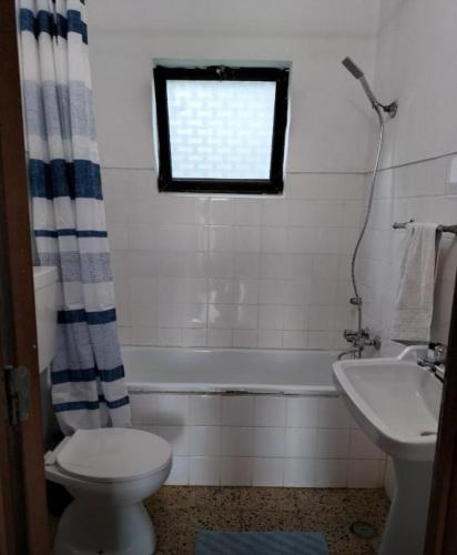 a bathroom with a toilet and a tub and a sink at Country House Silves in Silves