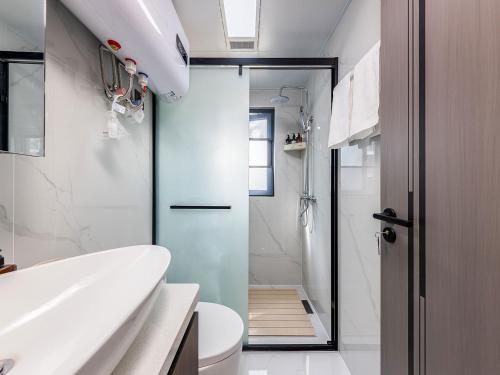 a bathroom with a shower and a toilet and a sink at Annie 2704-only 260 metres from Metro Line 2 Exit C of BeiChun in Kunming