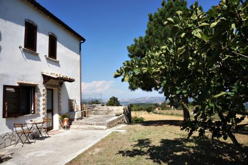 a house with a tree in front of it at La Campagna del Benessere in Gildone