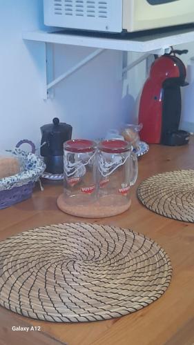 two glass jars sitting on top of a wooden table at Los Abrigos 2 apartments Guest House Ocean relax, wifi, playas in Los Abrigos