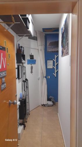 a hallway with a room with blue walls at Los Abrigos 2 apartments Guest House Ocean relax, wifi, playas in Los Abrigos