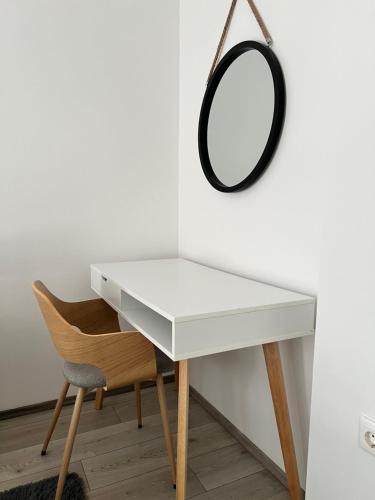 a white desk with a mirror and a chair at Apartman L, SELF CHECK IN, FREE PARKING in Karlovac