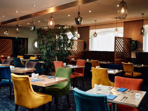 a dining room with tables and chairs at Hotel De Normandie in Saint Helier Jersey