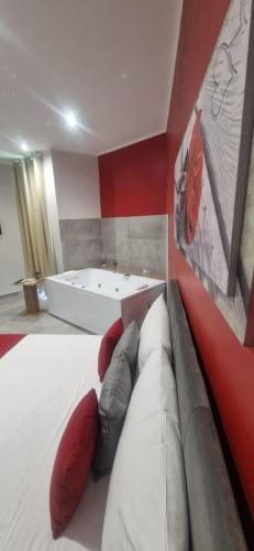 a bedroom with a bed and a bath tub at Hotel Movida in Casoria