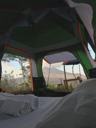 a green tent with a view of the desert at Kintamani Adventures 'Hide in Nature lodge' in Kintamani