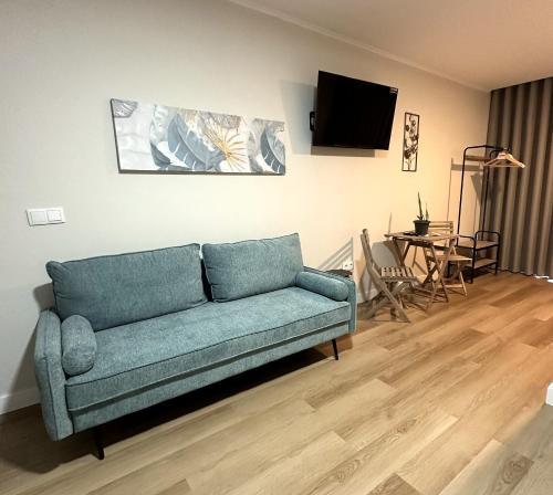 a living room with a couch and a table at Oásis Suites - Funchal in Funchal