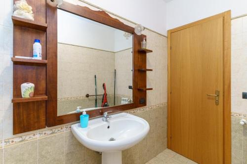 a bathroom with a sink and a mirror at Little Rose garden in Aci Catena