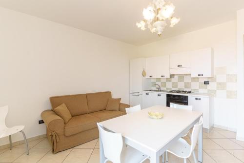 a living room with a white table and a couch at Little Rose garden in Aci Catena