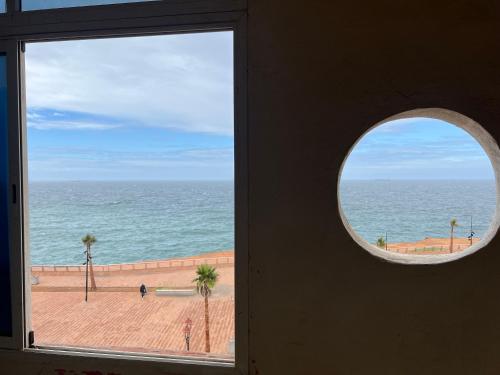 a window with a view of the ocean at Vu sur corniche in Safi