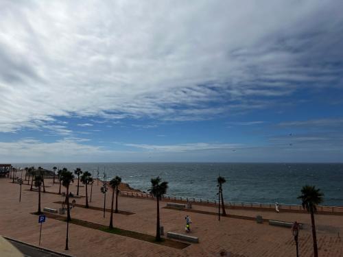 a beach with palm trees and the ocean at Vu sur corniche in Safi