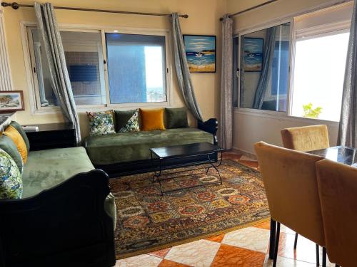 a living room with a couch and a table at Vu sur corniche in Safi