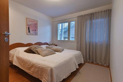a bedroom with a bed with pillows and a window at Central Alley 3B - including linen and towels in Levi
